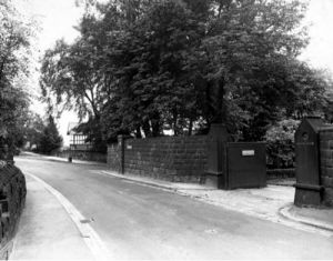 26/07/1950. Picture shows Spen Lane looking south east towards Abbey Walk and Morris Lane junction. The entrance to the property called "Crooked Acres" is visible to the right. Trees are visible throughout the whole picture. The old house can be seen poking through the trees in the far right hand side of the road. 